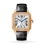 The Santos de Cartier by Cartier features a square rose gold case, diamond bezel, white dial with black Roman numerals and blue hands, black leather strap, automatic movement, and a crown set with a blue gemstone.