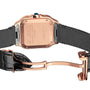 Close-up of the Santos de Cartier by Cartier, featuring a rose gold case, leather strap, visible deployment clasp, and engraved automatic winding details on the caseback.