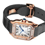 The Santos de Cartier by Cartier features a square face, Roman numerals, diamond bezel, rose gold case, black leather strap, blue crown, and automatic movement.