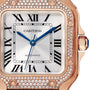 Close-up of the Santos de Cartier watch face with Roman numerals, blue hands, and a diamond-set rose gold bezel by Cartier, showcasing its automatic movement.