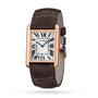 The Cartier Tank Louis Cartier watch features a rectangular rose gold case, white dial with black Roman numerals, blue hands, brown leather strap, and a signature sapphire cabochon.