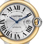 Close-up of the Cartier Ballon Bleu de Cartier watch face featuring Roman numerals, 18K yellow gold and silver bezel, blue hands, date window at 3 o’clock, and AUTOMATIC text for its Calibre 1847 MC automatic movement.