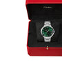 A Ballon Bleu de Cartier silver watch with a green face, presented in a red Cartier box with a black interior.
