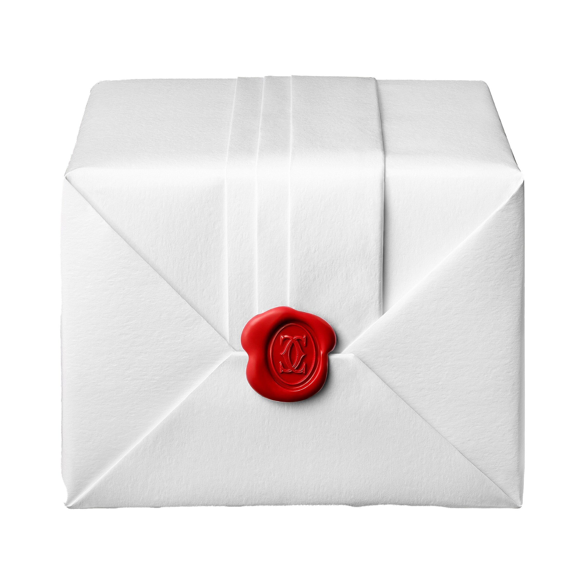 A Ballon Bleu de Cartier envelope by Cartier, sealed with a red wax seal embossed with a monogram.