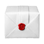 A Ballon Bleu de Cartier envelope by Cartier, sealed with a red wax seal embossed with a monogram.