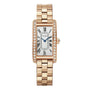 The Cartier Tank Américaine is a rectangular watch in rose gold, featuring a metal link band, diamond bezel, Roman numeral hour markers, and blue hands.
