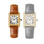 Two Tank Louis Cartier watches by Cartier side by side—left in yellow gold with a brown leather strap and sapphire cabochon crown, right in grayscale; both feature refined Roman numeral dials.