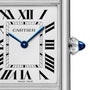 Close-up of the Cartier Tank Must Solarbeat™ Watch face with Roman numerals, blue hands, a steel case, and a blue cabochon crown—timeless elegance from Cartier in every detail.