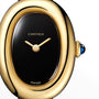 Cartier Baignoire wristwatch with an oval black face, gold hands, blue gem crown, shown close up.