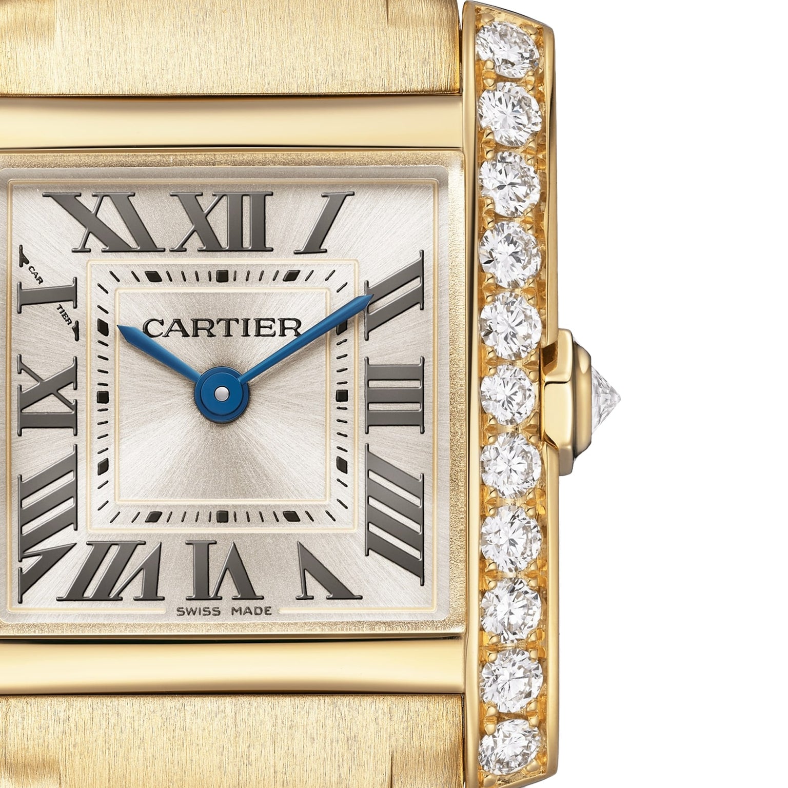 Close-up of the Cartier Tank Française watch, featuring a yellow gold case, Roman numerals, blue hands, and a brilliant-cut diamond-encrusted bezel on the right side of the face.