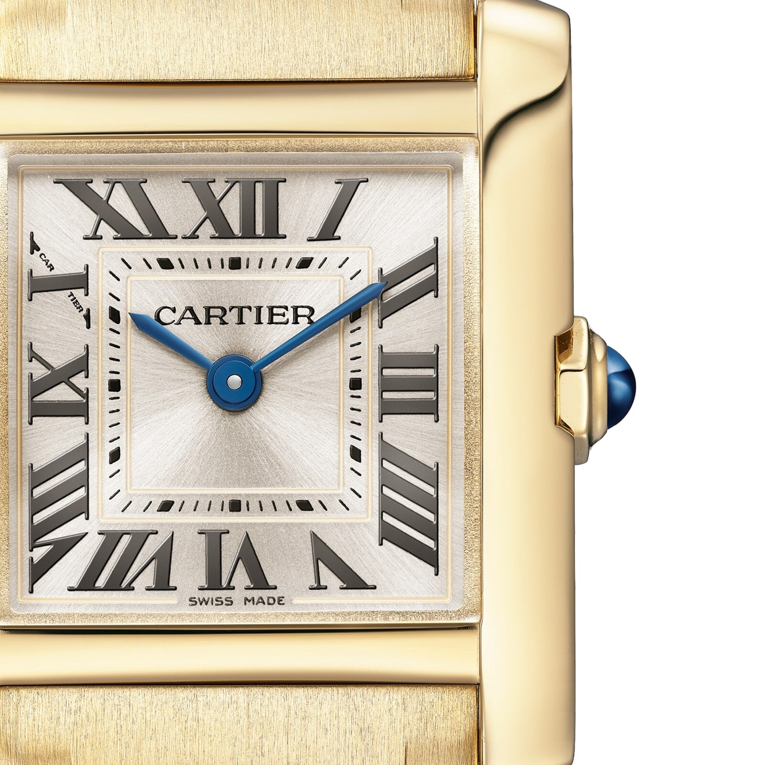 Close-up of the Cartier Tank Française watch, featuring a gold case, Roman numeral markers, blue hands, and a blue cabochon crown.