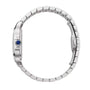 Side view of the Cartier Santos de Cartier, a silver metal wristwatch featuring a round blue crown and a linked bracelet-style band.