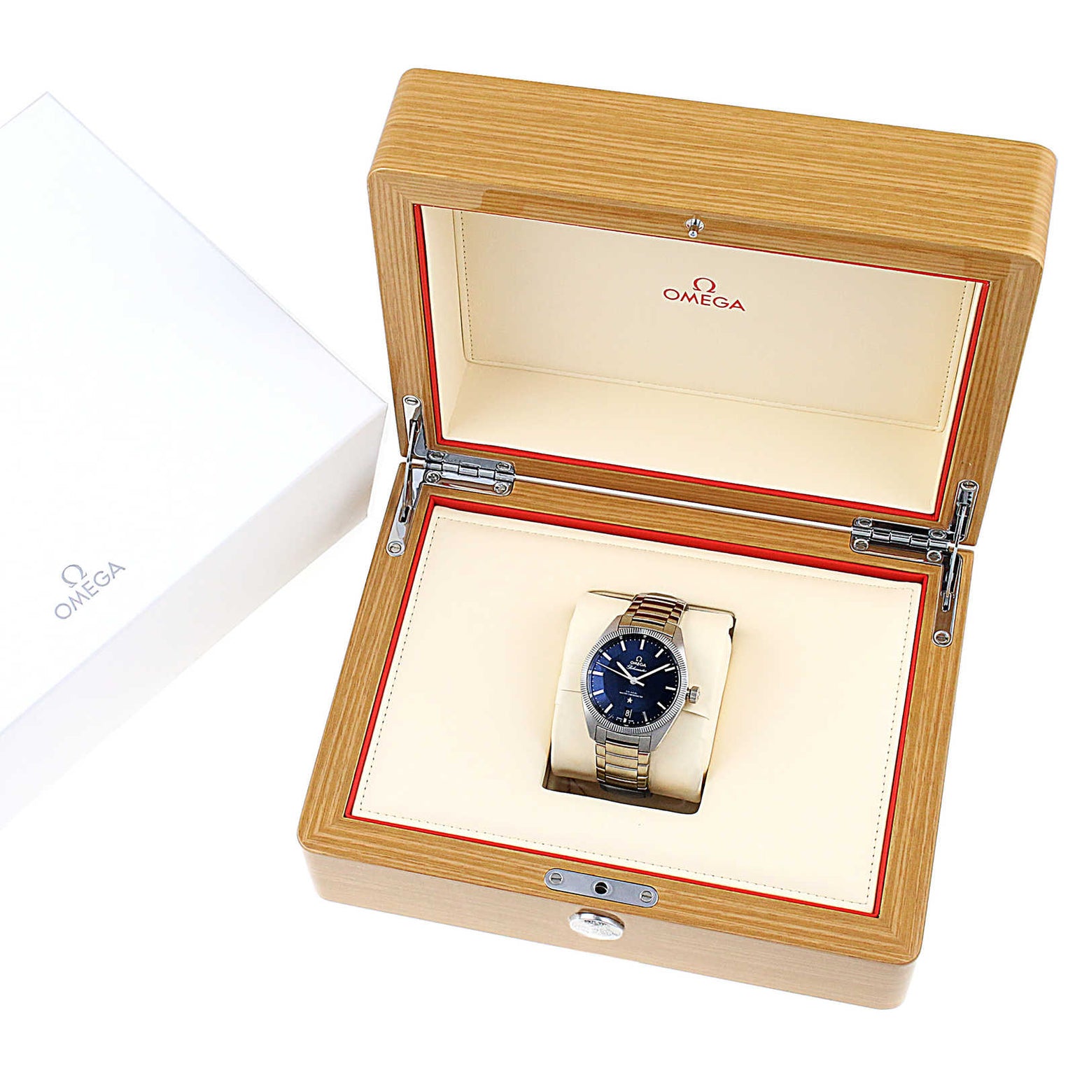 An OMEGA Constellation Globemaster wristwatch with a blue dial and stainless steel case, shown in an open wooden OMEGA presentation box beside a white OMEGA box.