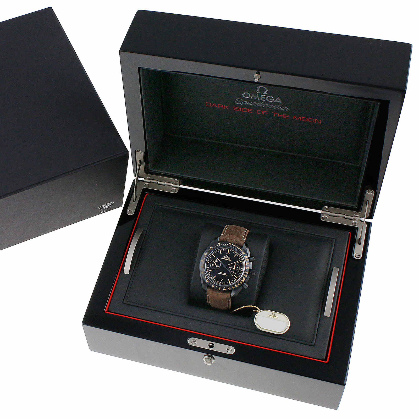 An OMEGA Speedmaster Dark Side of the Moon wristwatch with a brown strap and 9300 calibre movement is displayed in an open black presentation box.