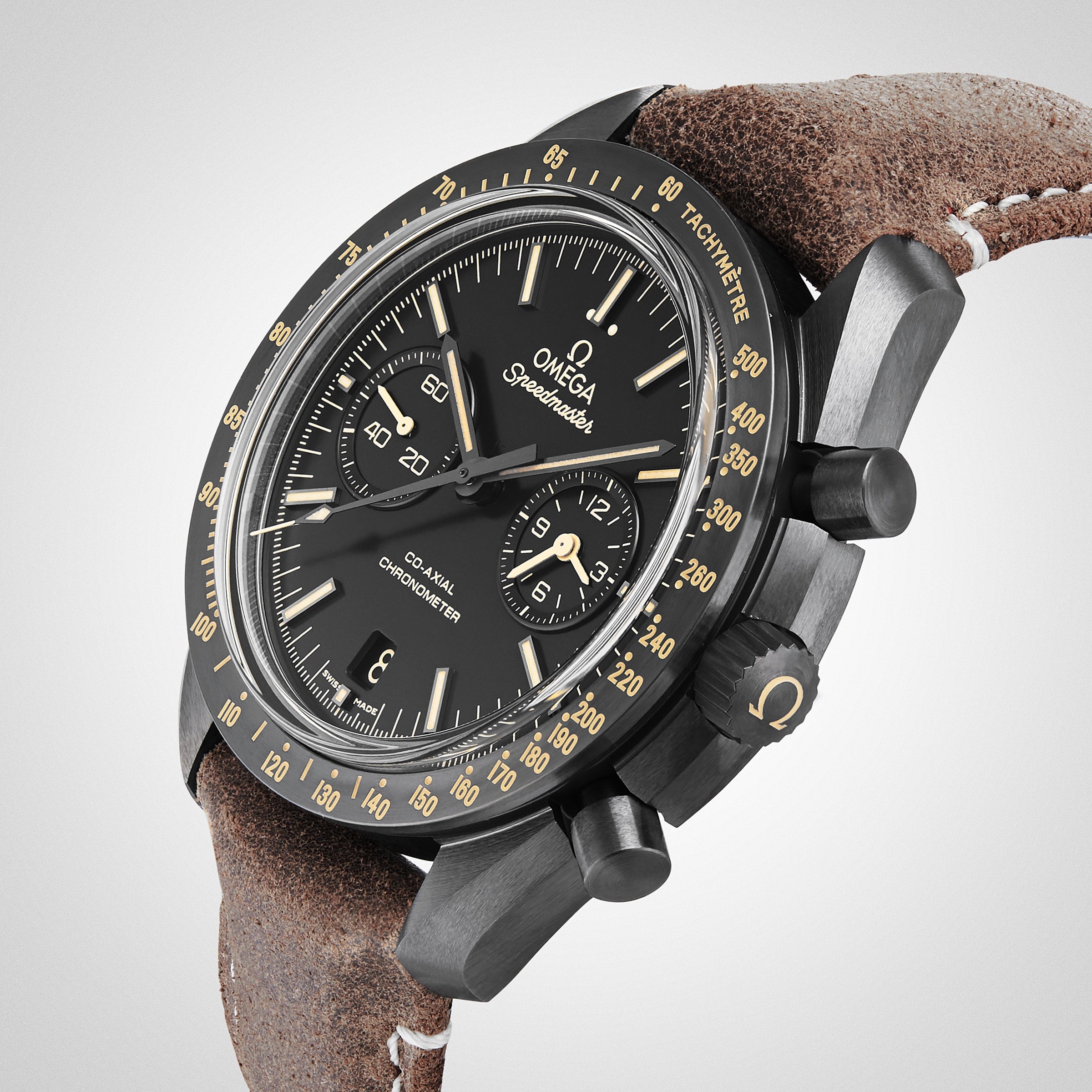 A close-up of the OMEGA Speedmaster Dark Side Of The Moon, featuring a black ceramic case, black dial, chronograph subdials, tan indices, and a brown leather strap.