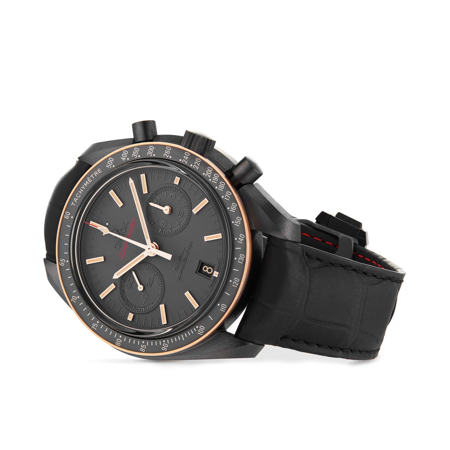 The OMEGA Speedmaster Dark Side Of The Moon Sedna Black is a luxury chronograph with a black ceramic case, black leather strap, three subdials, gold-tone hour markers, and a date window at 6 o’clock.