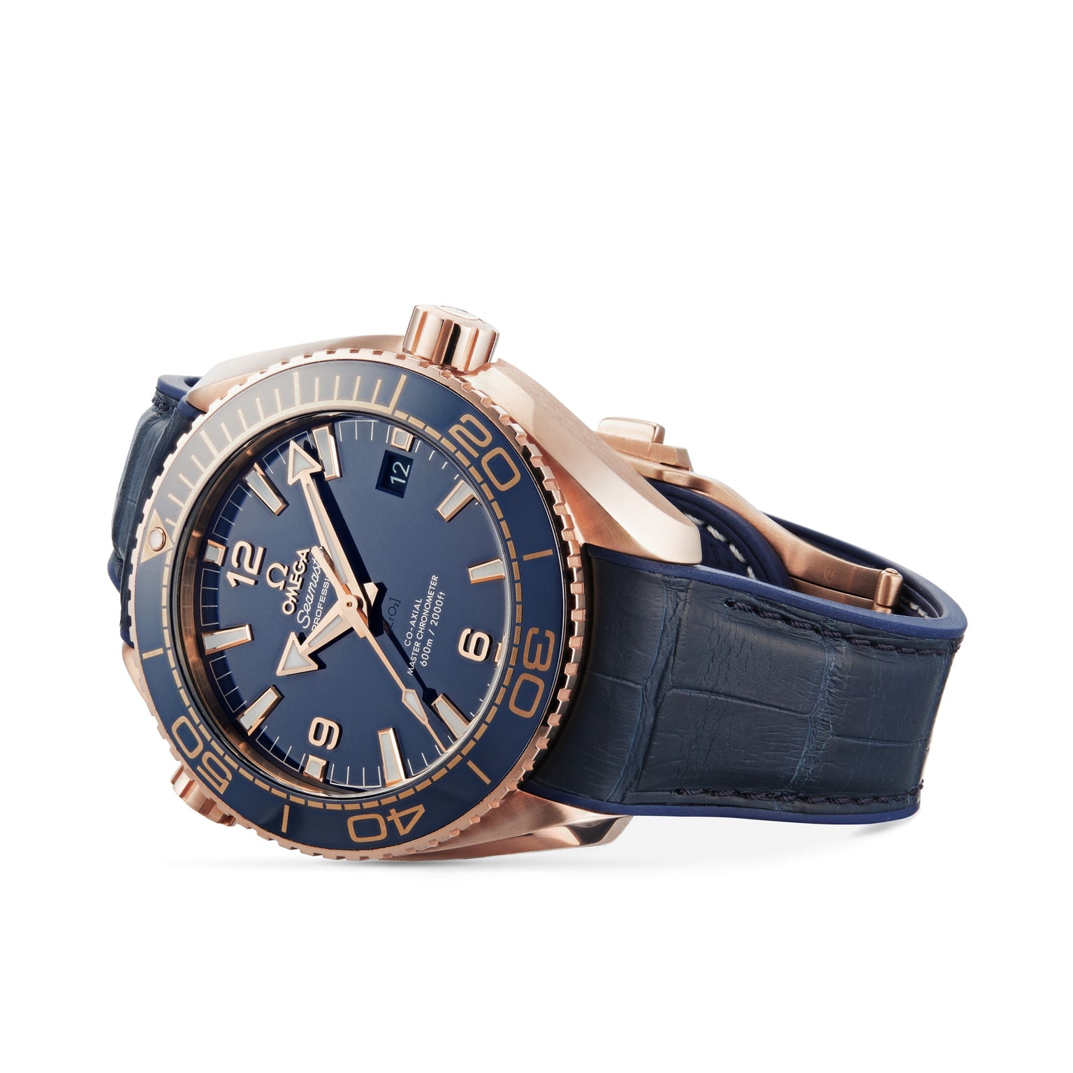 An OMEGA Seamaster Planet Ocean 600M wristwatch in blue and rose gold with a blue leather strap is shown on its side against a white background.