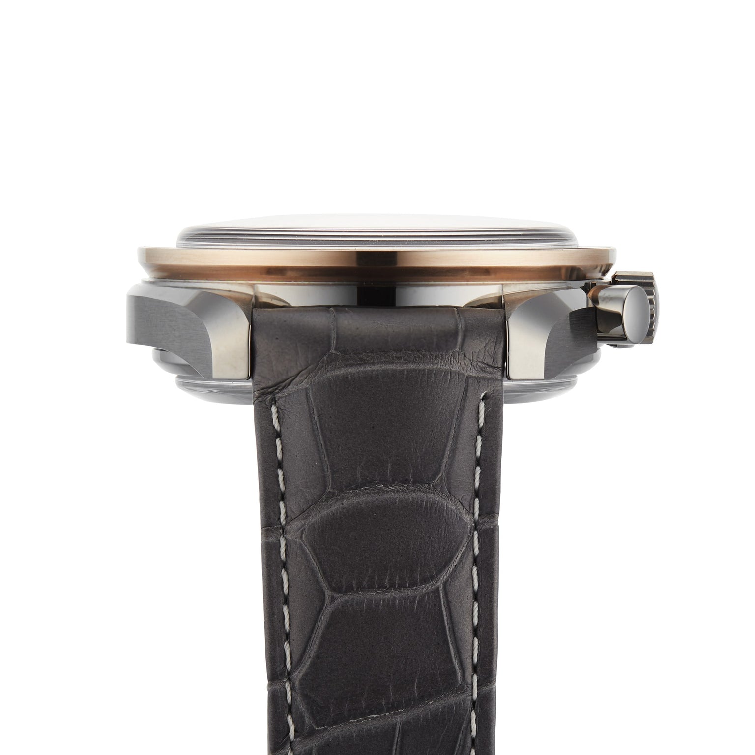 Side view of the OMEGA Speedmaster Dark Side of the Moon Meteorite with a round ceramic case, right-side crown, and black leather strap featuring white stitching.