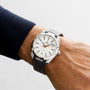 A close-up of a person wearing an OMEGA Seamaster Aqua Terra 150M with a white dial, black strap, and silver casing on their left wrist.