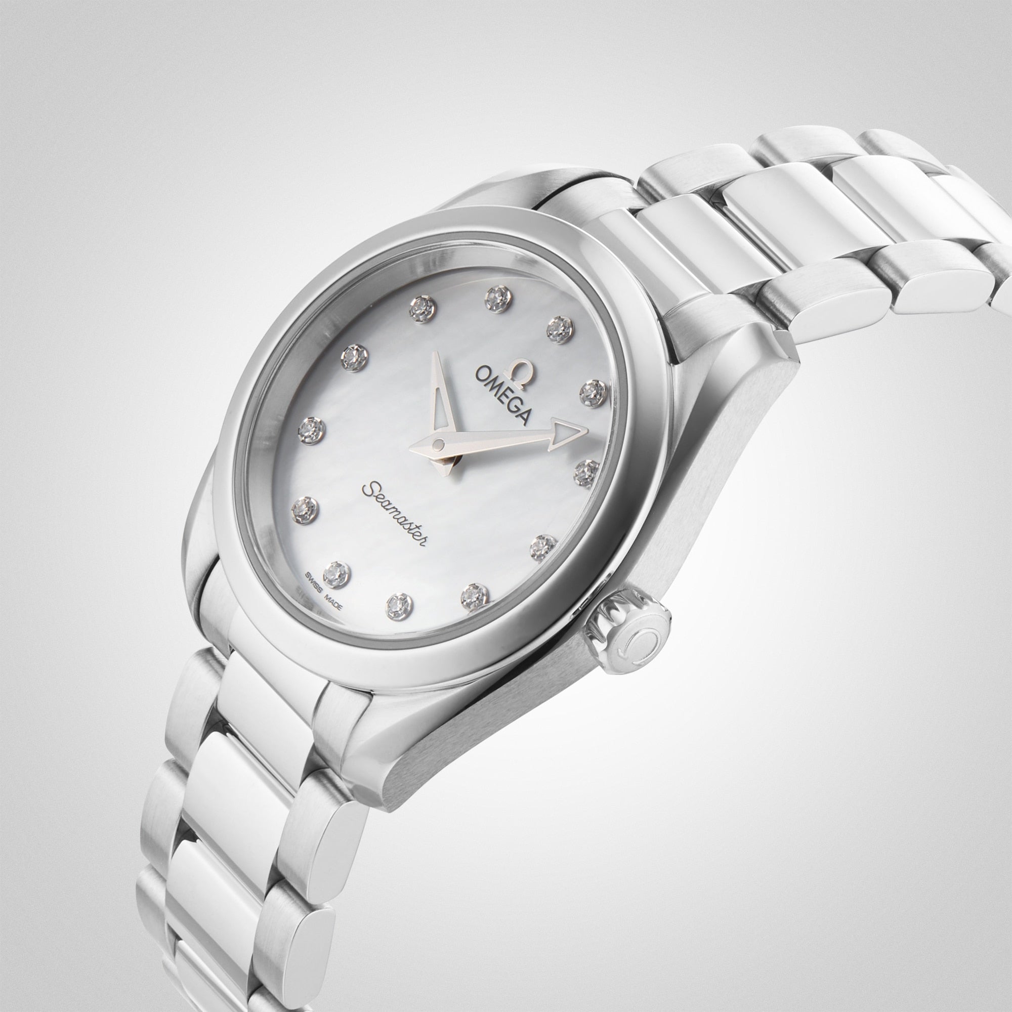 The OMEGA Seamaster Aqua Terra 150M features a stainless steel case, white mother-of-pearl dial with diamond hour markers, and a metal bracelet, shown on a light gray background.