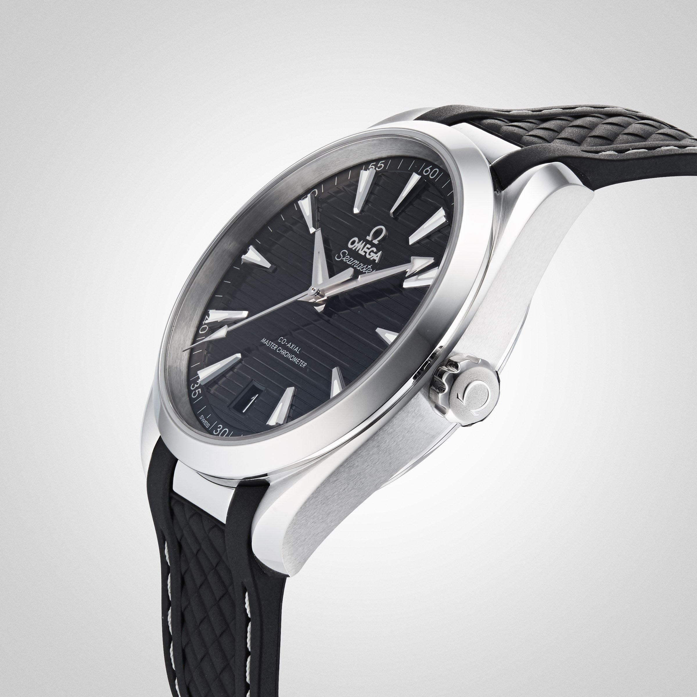 A close-up of an OMEGA Seamaster Aqua Terra 150M wristwatch featuring a black textured strap, black dial, silver hour markers, and OMEGA branding, set against a light gray background.