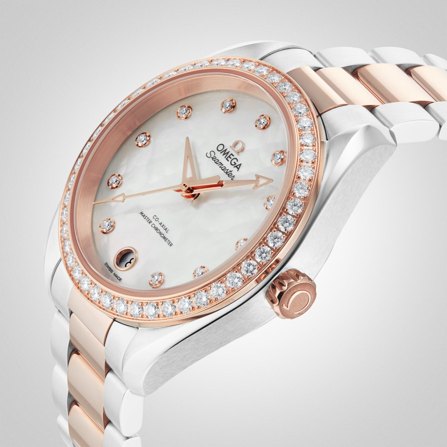 A close-up of an OMEGA Seamaster Aqua Terra 150M watch with a rose gold and silver band, diamond bezel, calibre 8800 movement, and a mother-of-pearl dial with diamond hour markers.