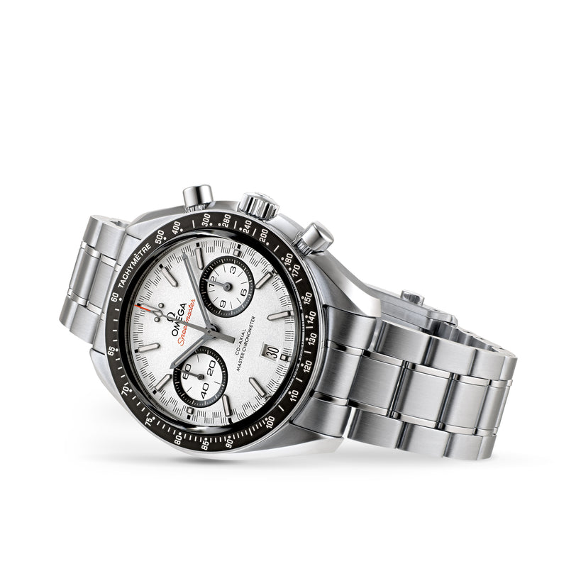 The OMEGA Speedmaster Racing features a stainless steel case, white dial, black bezel, silver bracelet, and 9900 calibre movement, all shown in an angled side view.