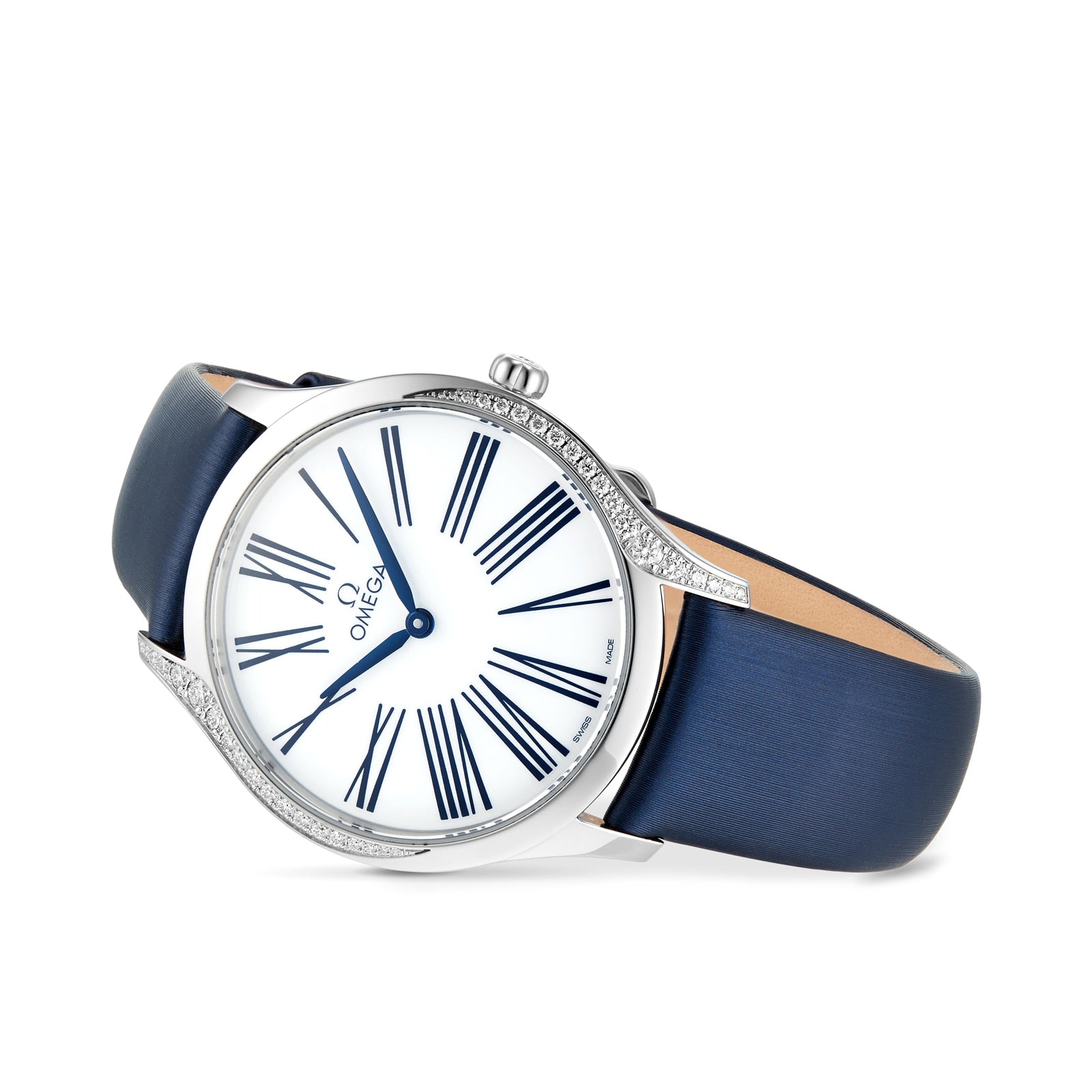 The OMEGA De Ville Tresor 36 is a ladies’ watch with a white dial, blue Roman numerals, a blue leather strap, and a silver case adorned with diamond paving for an elegant touch.