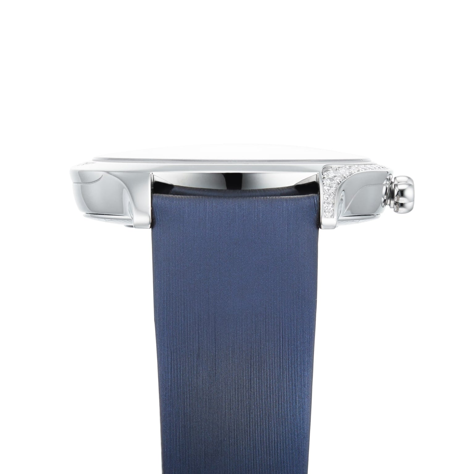 Side view of the OMEGA De Ville Tresor 36: a silver watch case, blue strap, and diamond accent near the crown, displayed against a white background.