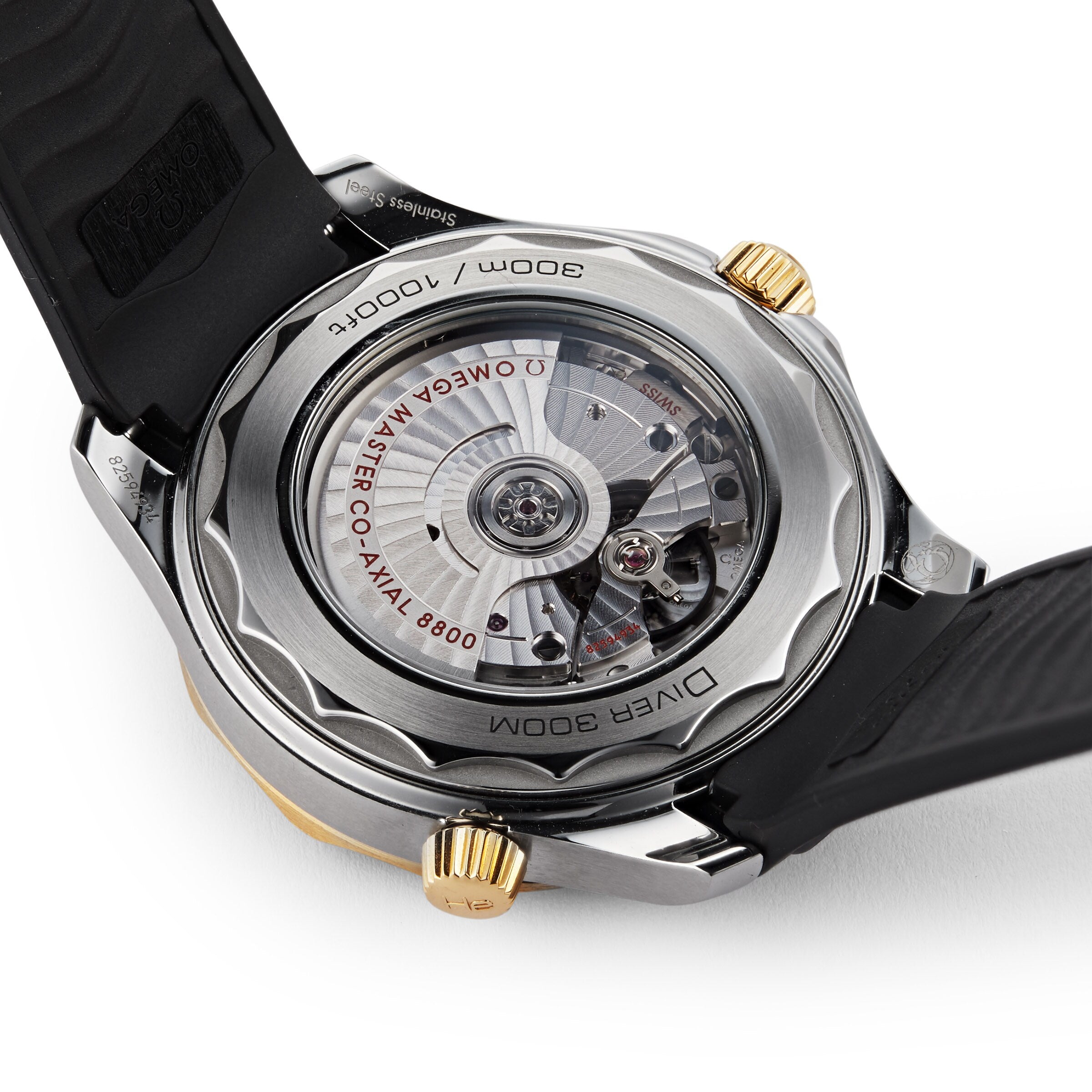 Close-up of the Seamaster Diver 300M by OMEGA, highlighting its exposed automatic movement and engraved markings on the stainless steel case back.