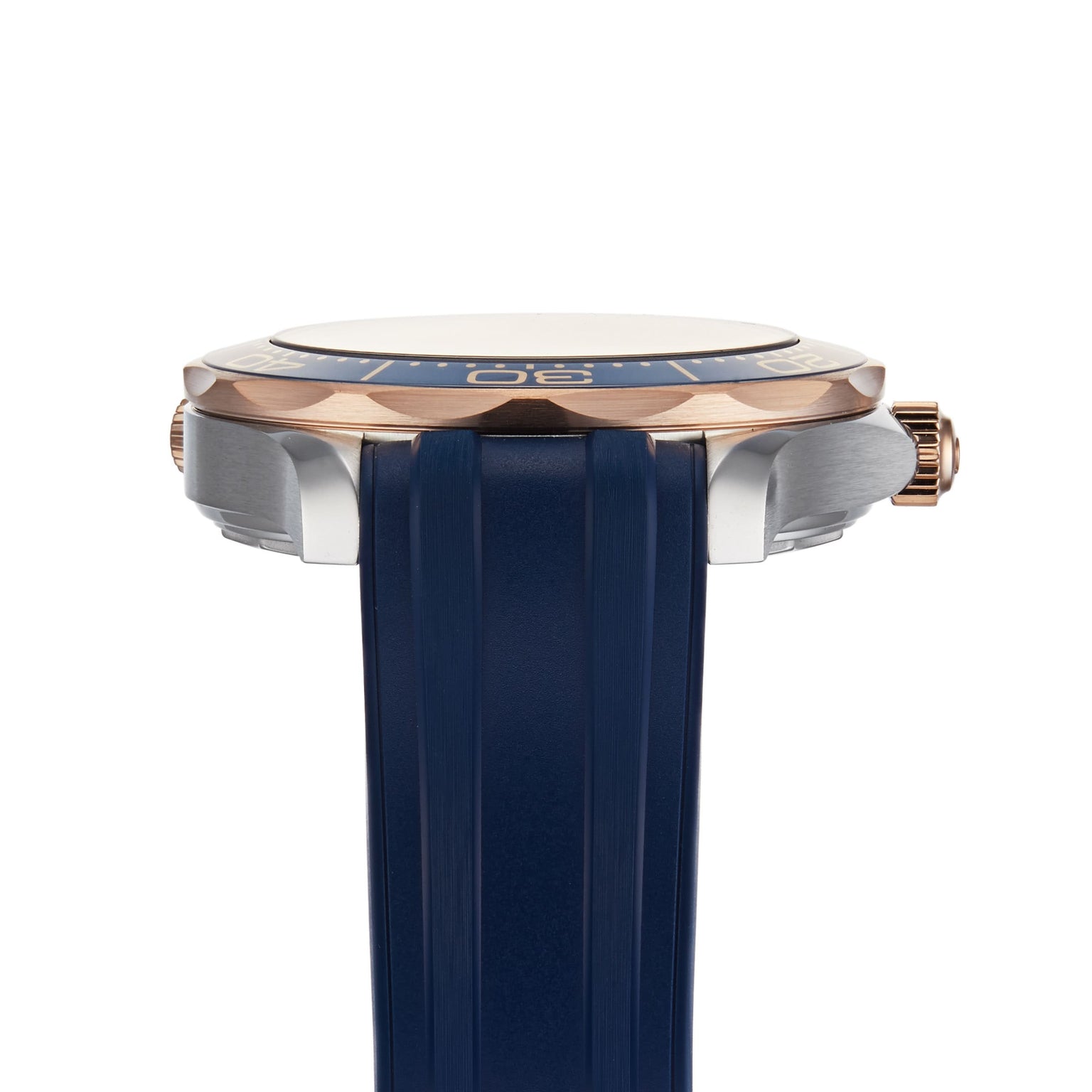 A close-up side view of the OMEGA Seamaster Diver 300M wristwatch with a blue strap, blue and gold bezel, and gold crown on the right, powered by the OMEGA Co-Axial Master Chronometer calibre 8800 movement.