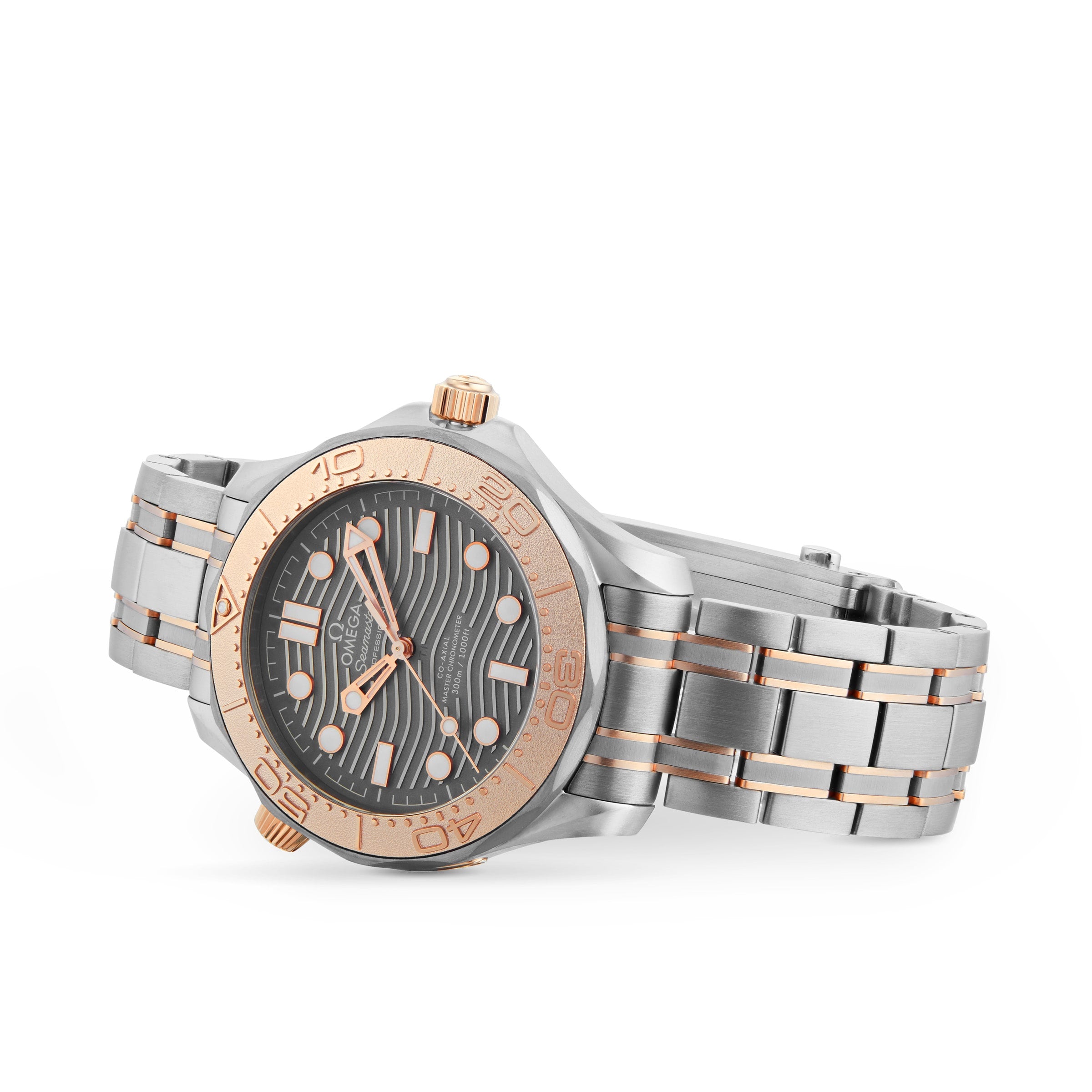 The OMEGA Seamaster Diver 300M is a silver and rose gold wristwatch with a black patterned dial, white hour markers, and a metal link band, photographed on white. This limited edition boasts the Co-Axial Master Chronometer movement.