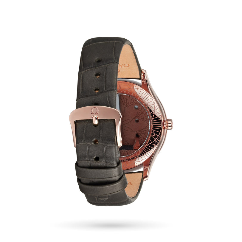 The OMEGA De Ville Tresor 36 is a luxury ladies’ watch featuring a black leather strap, Sedna™ gold buckle, and an exhibition case back highlighting its intricate mechanical design.