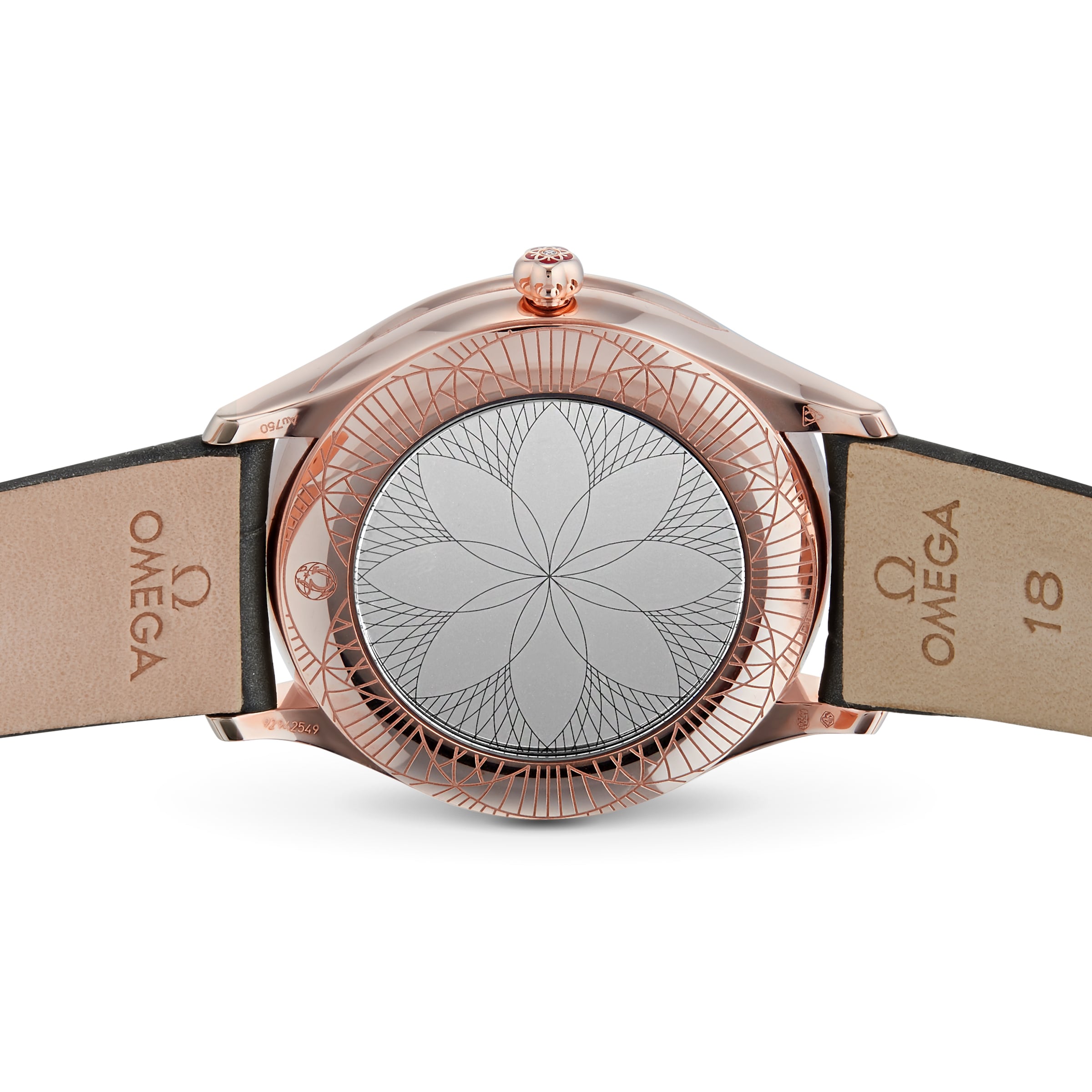 The OMEGA De Ville Tresor 36 features a geometric flower-engraved Sedna™ gold caseback and leather straps, both accented with the iconic Omega logo.