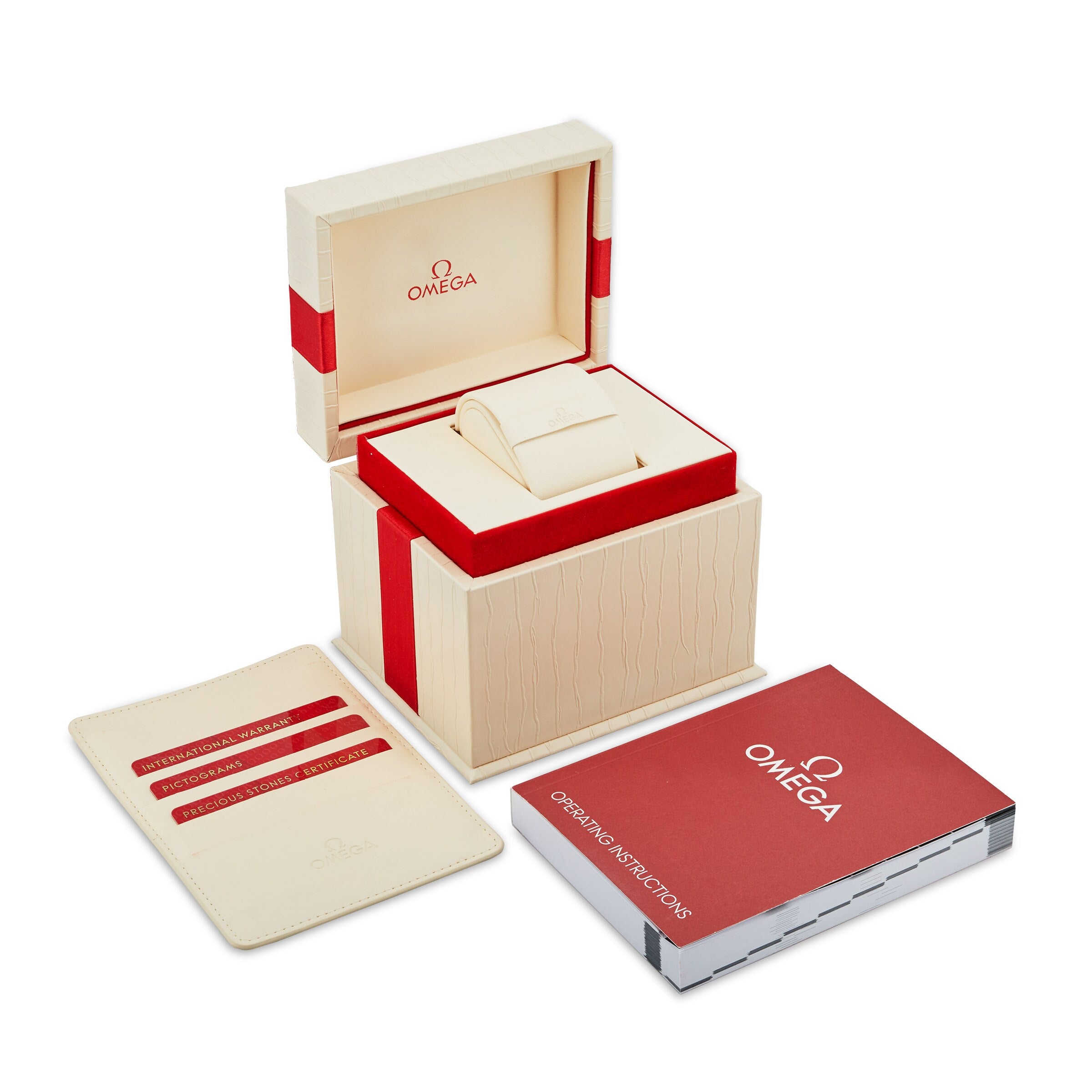 An open OMEGA watch box with a cushion, card holder set, and operating instructions booklet—ideal for displaying your cherished De Ville Tresor 36.