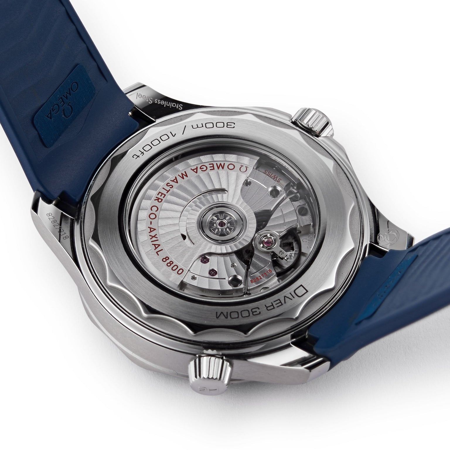 The Seamaster Diver 300M from OMEGA features an exposed Calibre 8800 movement, engraved details, and a blue rubber strap—perfect for any James Bond watch fan.