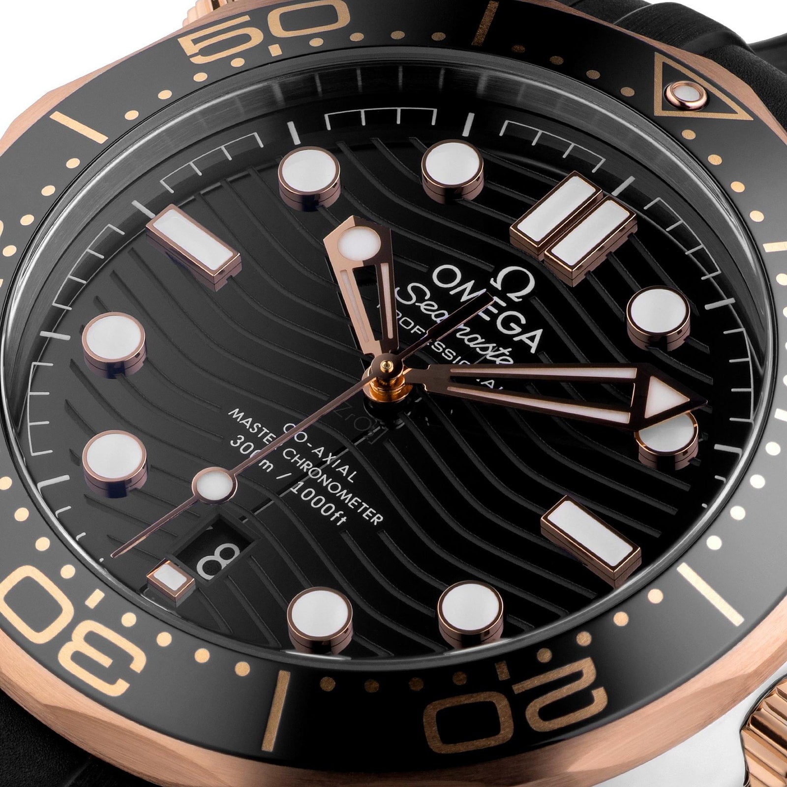 Close-up of the OMEGA Seamaster Diver 300M watch with a black wave-patterned dial, Ceragold bezel and markers, and a date window at 6 o’clock. This luxury Master Chronometer showcases OMEGA’s precision craftsmanship.