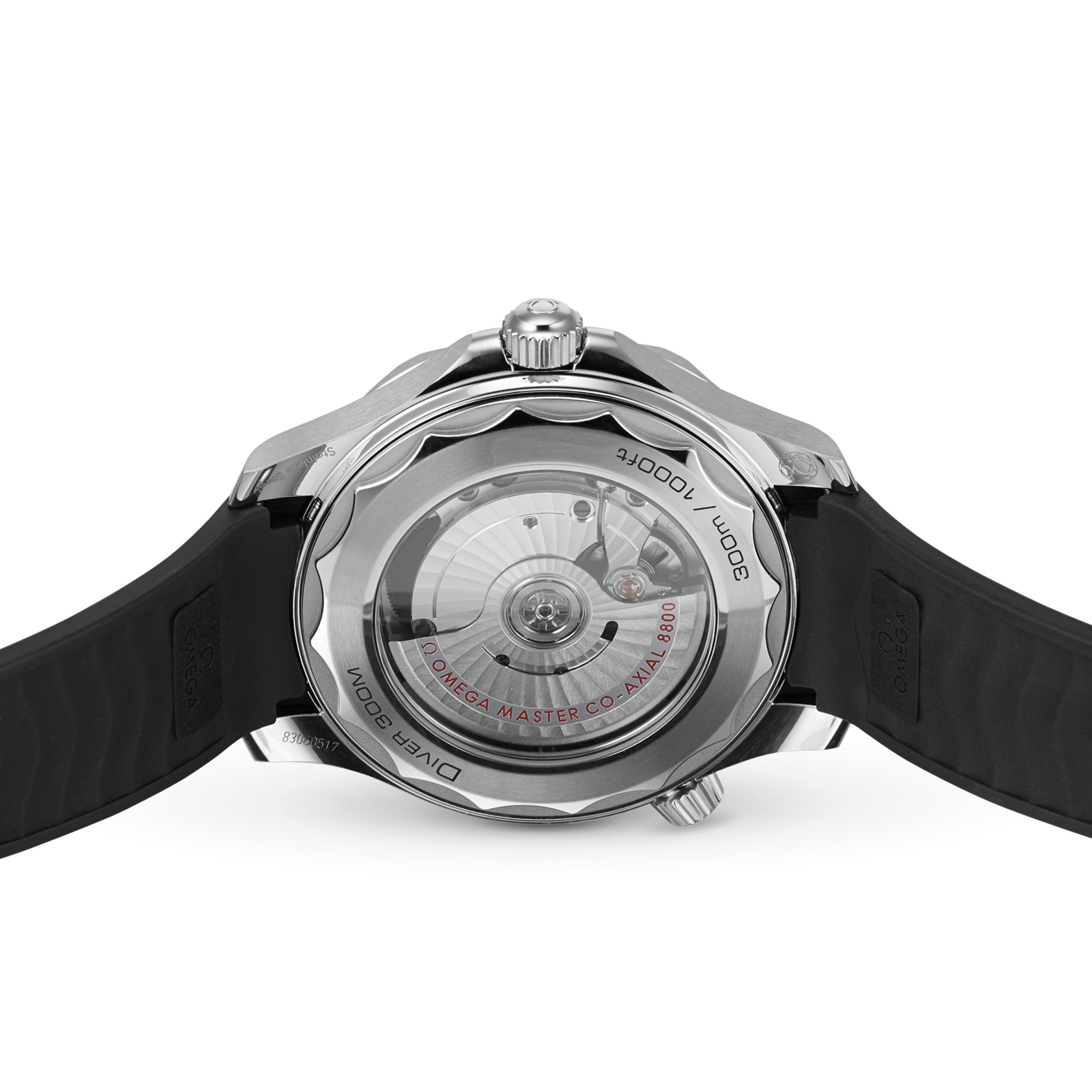 A close-up view of the back of an OMEGA Seamaster Diver 300M shows its automatic movement, Diver 300M markings, and a black rubber strap paired with a sleek black ceramic bezel.