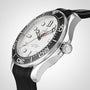 A close-up side view of the OMEGA Seamaster Diver 300M watch with a black ceramic bezel, white dial, black rubber strap, and stainless steel case set against a neutral background.