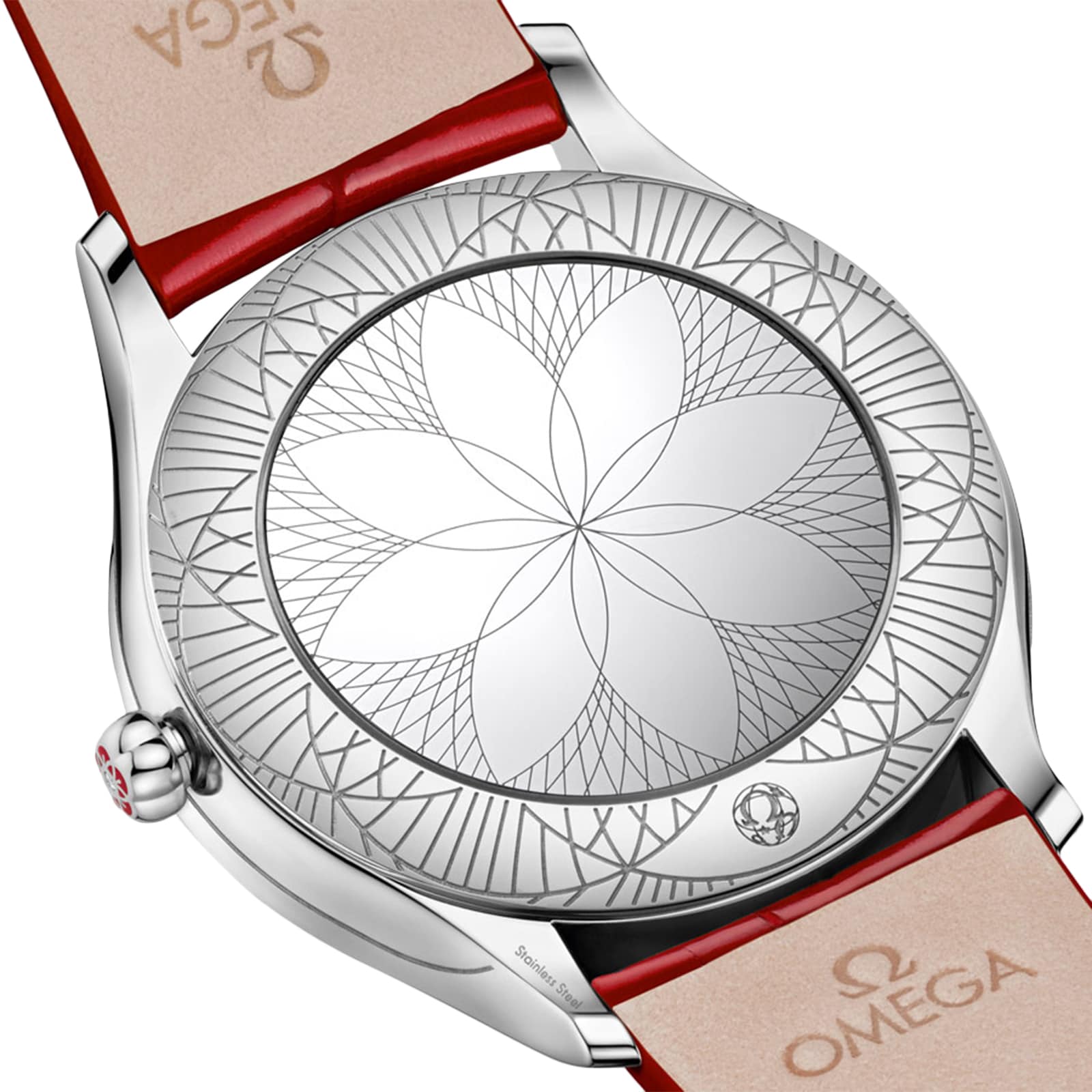 Close-up of the back of an OMEGA De Ville Trésor 36 wristwatch, showcasing an engraved geometric flower motif, red leather strap, and OMEGA branding on the inside of the band.