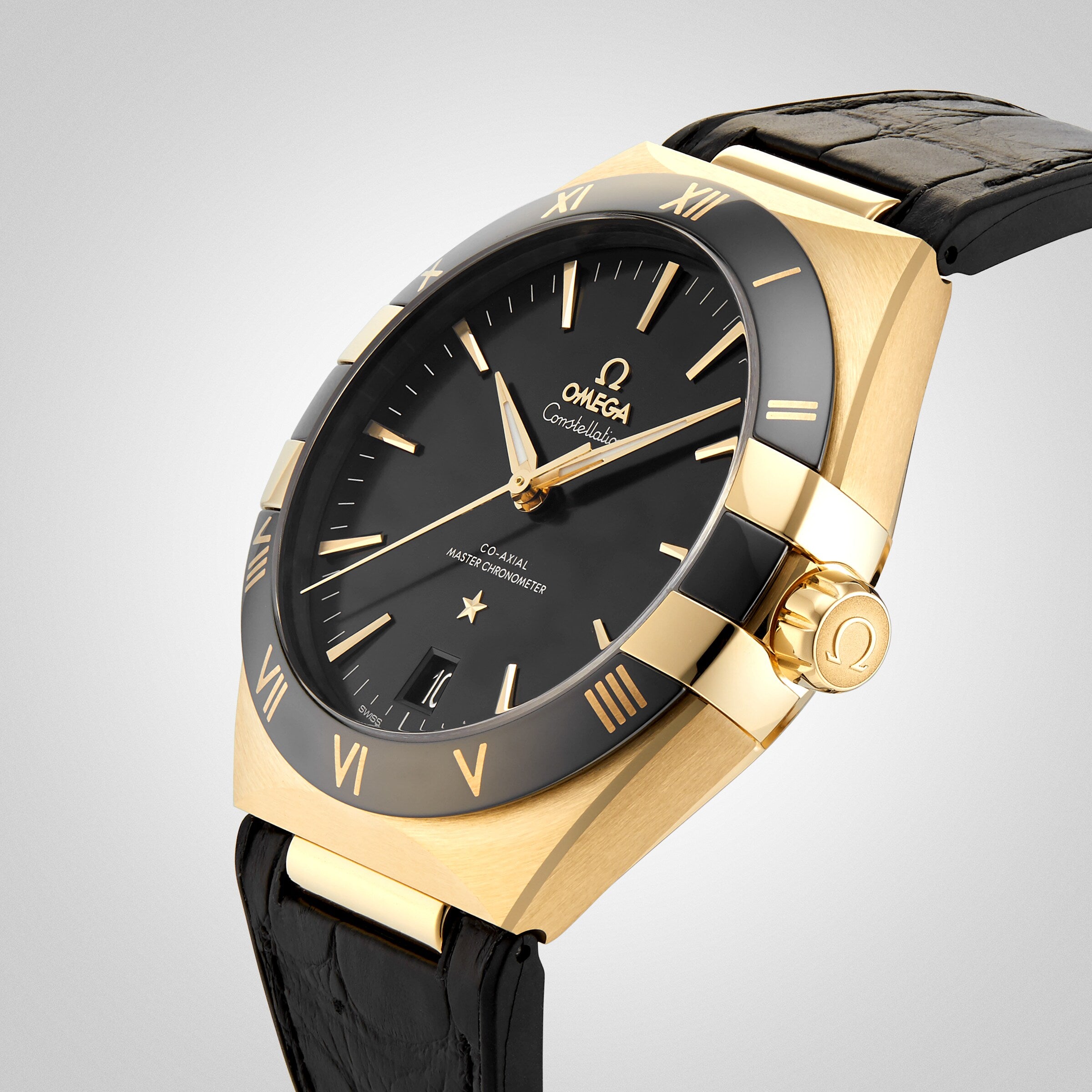 A gold OMEGA Constellation wristwatch with a black face, gold hour markers, Roman numerals on the bezel, and a black leather strap features the 8901 calibre movement, photographed at an angle against a neutral background.