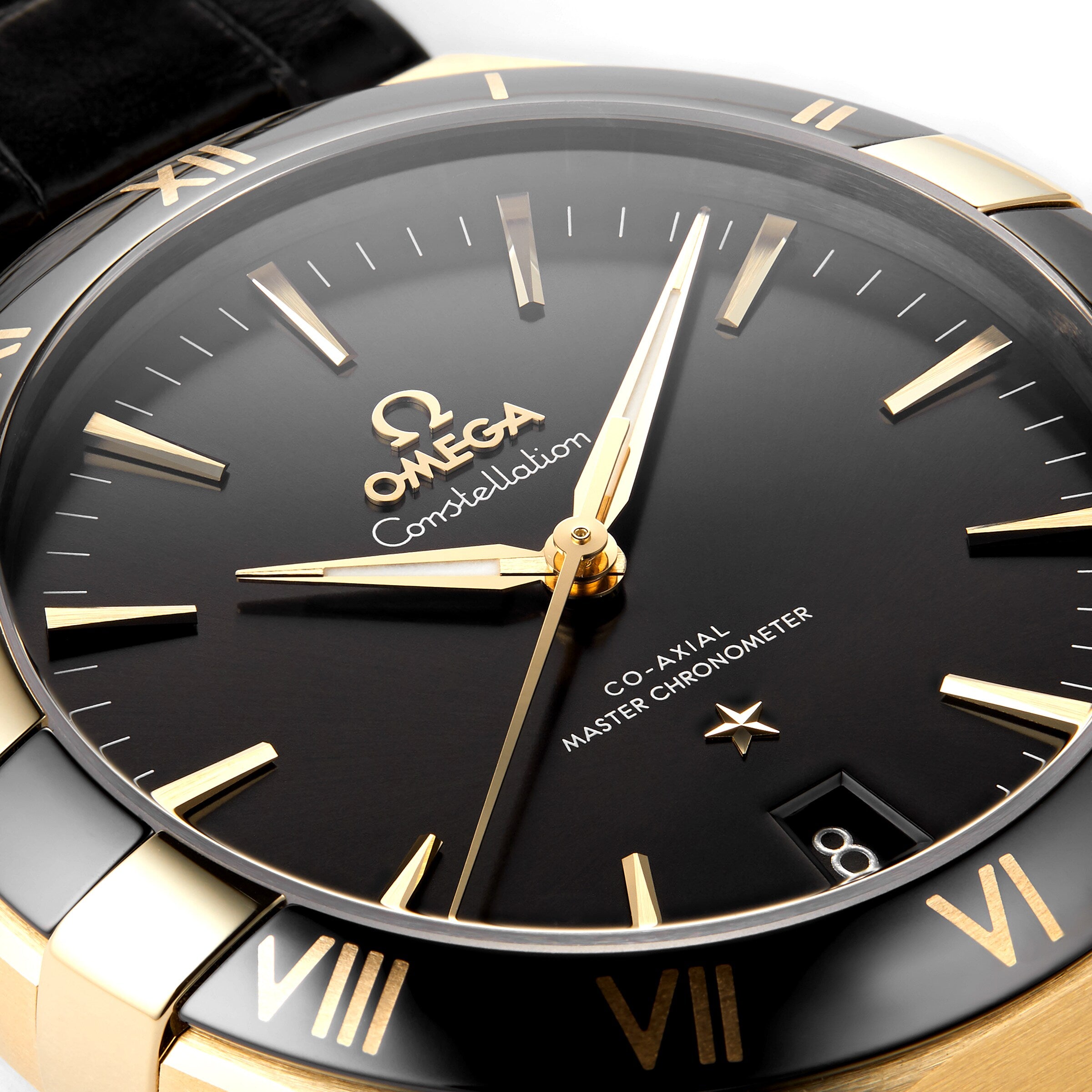 Close-up of an OMEGA Constellation watch with a black dial, gold markers and hands, and a date window at 8, celebrating its Constellation heritage and powered by the Master Chronometer certified 8901 calibre movement.