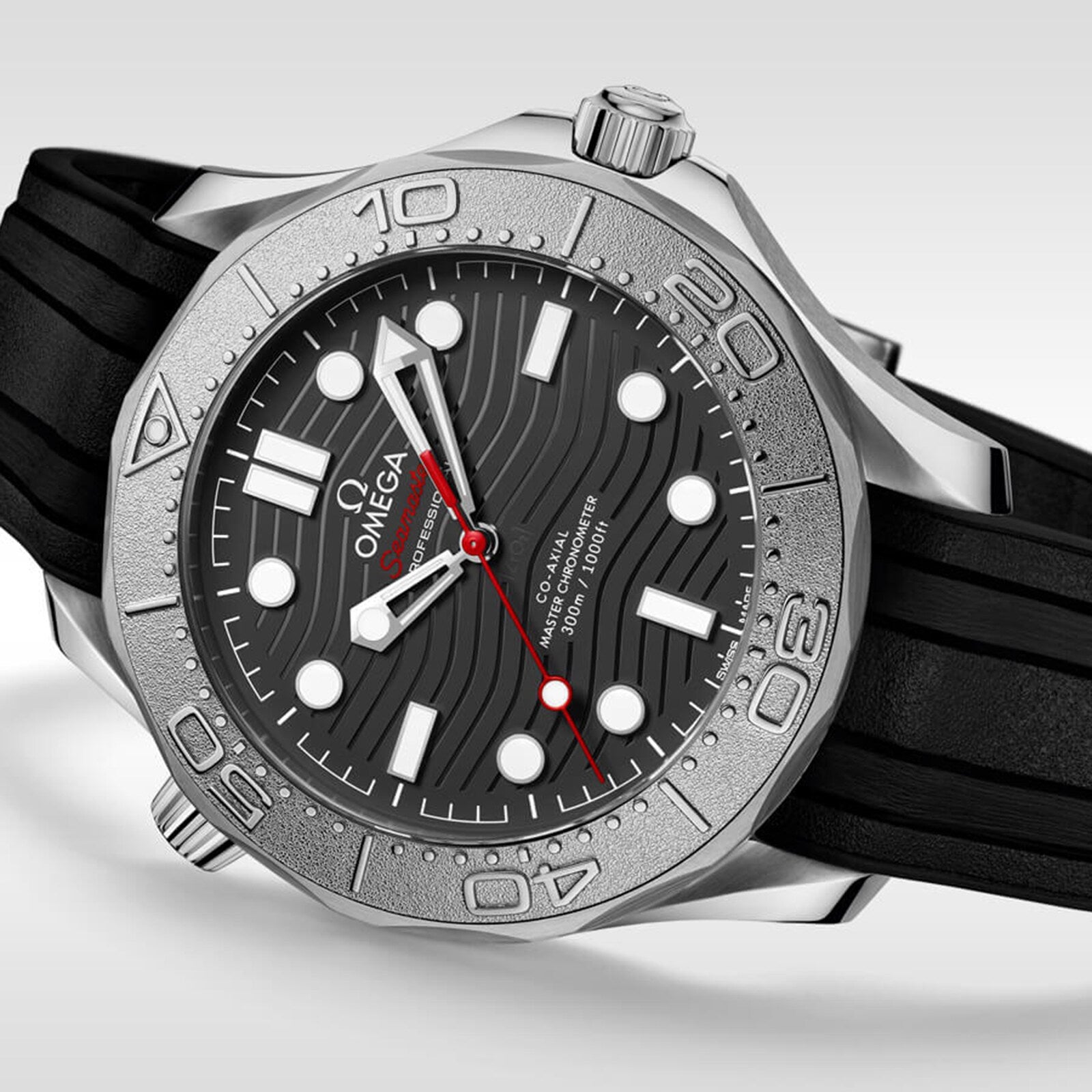 OMEGA Seamaster Diver 300M Nekton Edition wristwatch in stainless steel, featuring a black textured dial with white markers, red-tipped second hand, and black rubber strap, shown on a light gray background.
