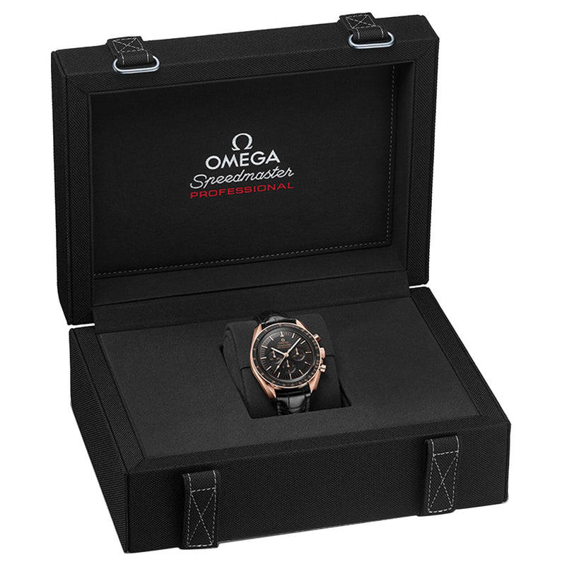 An OMEGA Speedmaster Moonwatch Professional wristwatch with a black leather strap and 3861 calibre movement, shown in an open black presentation box with white stitching.