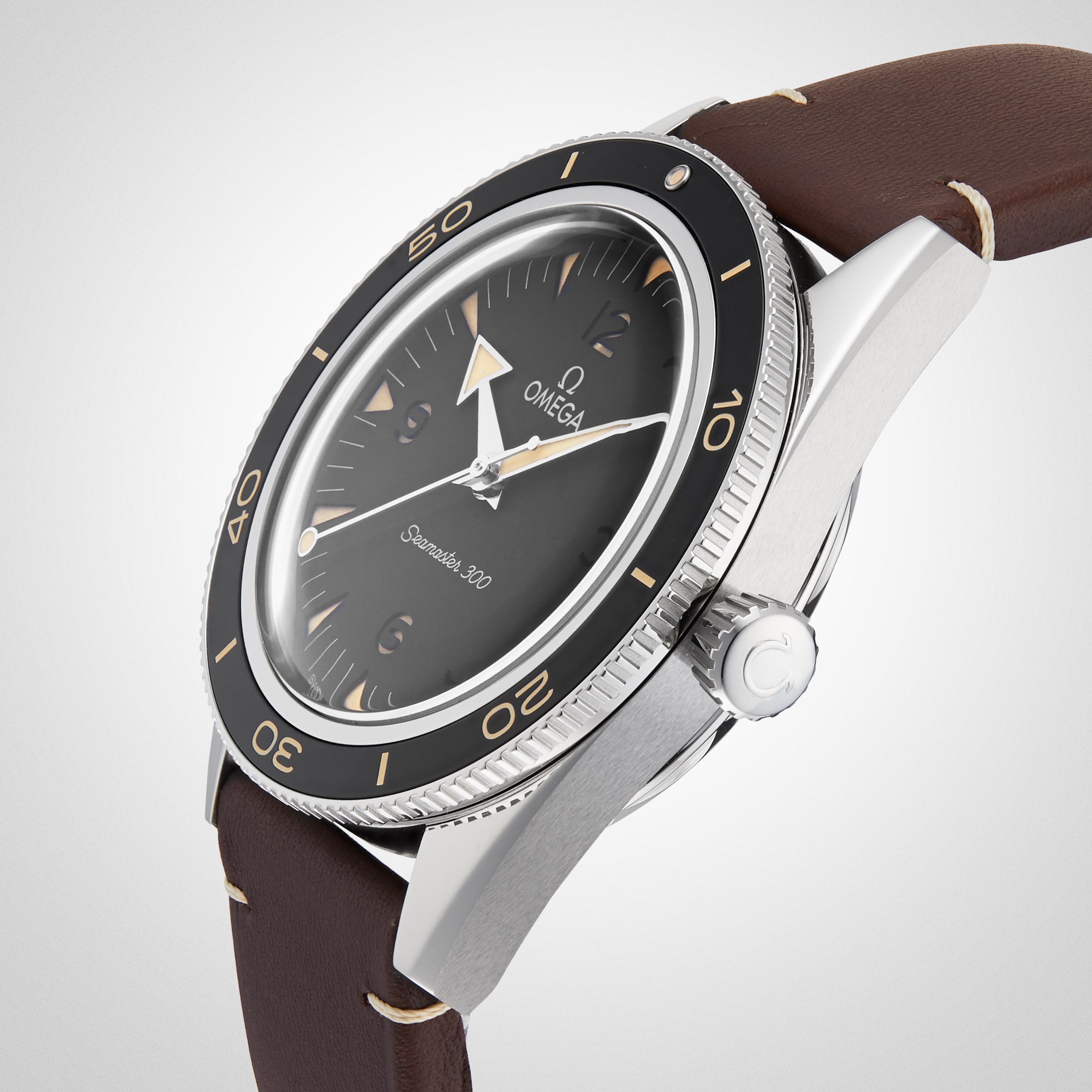 A close-up of the OMEGA Seamaster 300 wristwatch features a black dial, silver bezel, and brown leather strap, highlighting its Co-Axial Master Chronometer Calibre 8912 movement against a plain background.