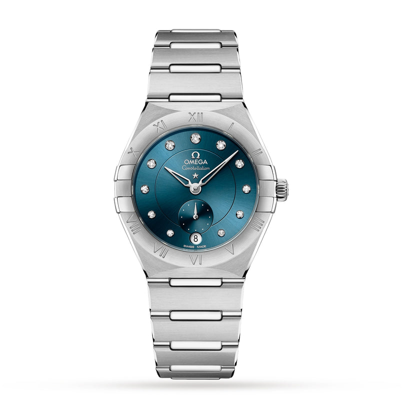 The OMEGA Constellation is a 34mm stainless steel watch featuring a blue dial, diamond hour markers, Roman numerals on the bezel, and a date display at 6 o’clock.
