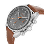 A close-up of the OMEGA Speedmaster 38 features a brown leather strap, grey dial, three subdials, and orange accents, highlighting its sporty style and precise 3330 calibre movement.