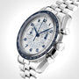 The OMEGA Speedmaster Chronoscope, featuring a stainless steel case, white and blue dial, tachymeter bezel, chronograph pushers, and metal link bracelet, is photographed against a light background.