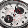 Close-up of the OMEGA Speedmaster Chronoscope watch face with black subdials, red accents, a tachymeter scale, and precise central hands displaying the time.