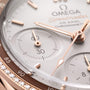 Close-up of the OMEGA Speedmaster 38 watch face, featuring 18K Sedna™ gold hands, chronograph dials, a diamond-set bezel, and powered by the Co-Axial Calibre 3330.